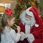 James Pruss as Santa Claus listening to Christmas wishes.