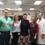 Ortho research team poses with golfer Austin Cook