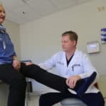 Dr. Edwards examines a patient's leg